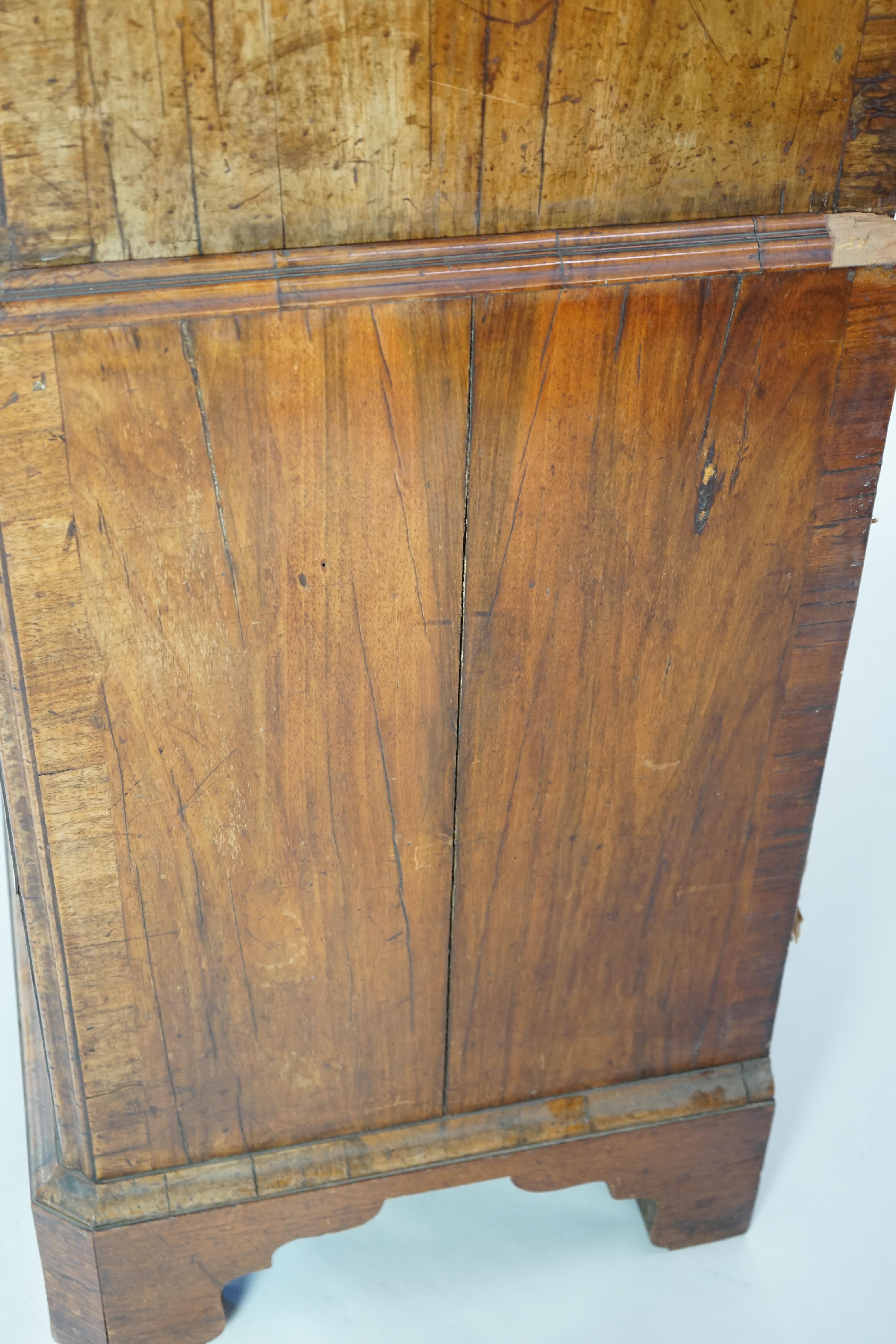 A George II feather banded walnut chest on chest